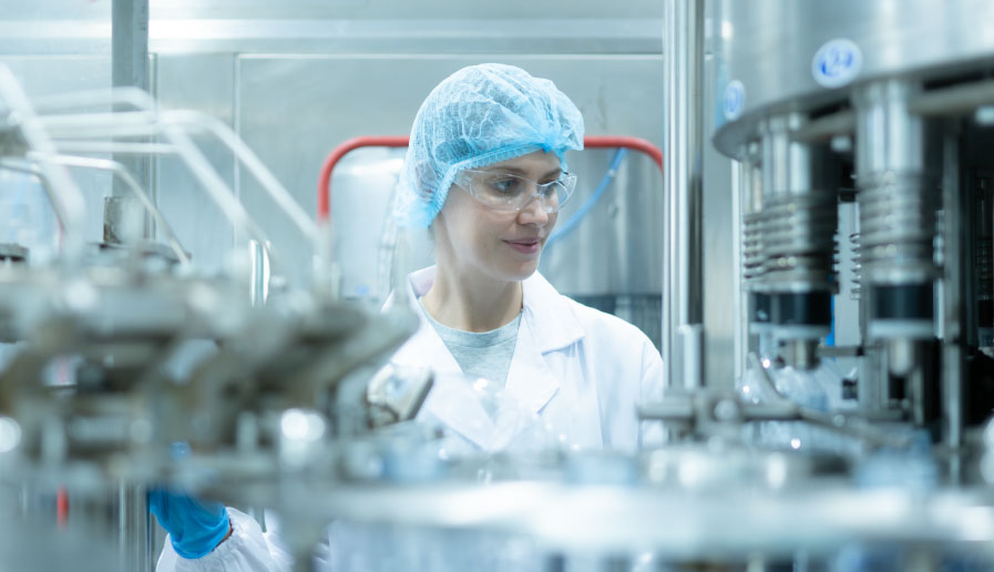 Worker in clean gear supervising machines